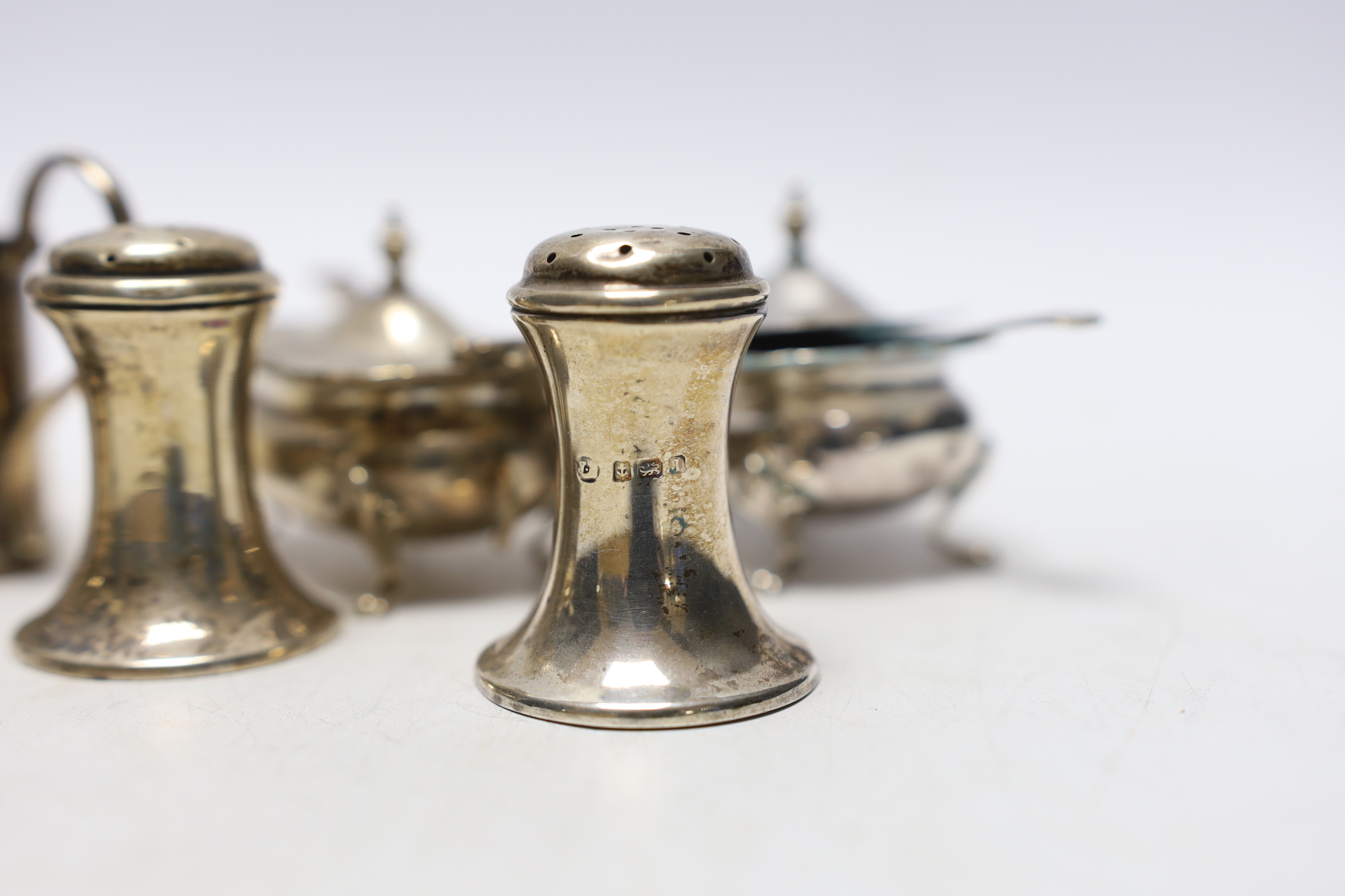 Ten assorted silver cruets, including mustards and pepperettes.